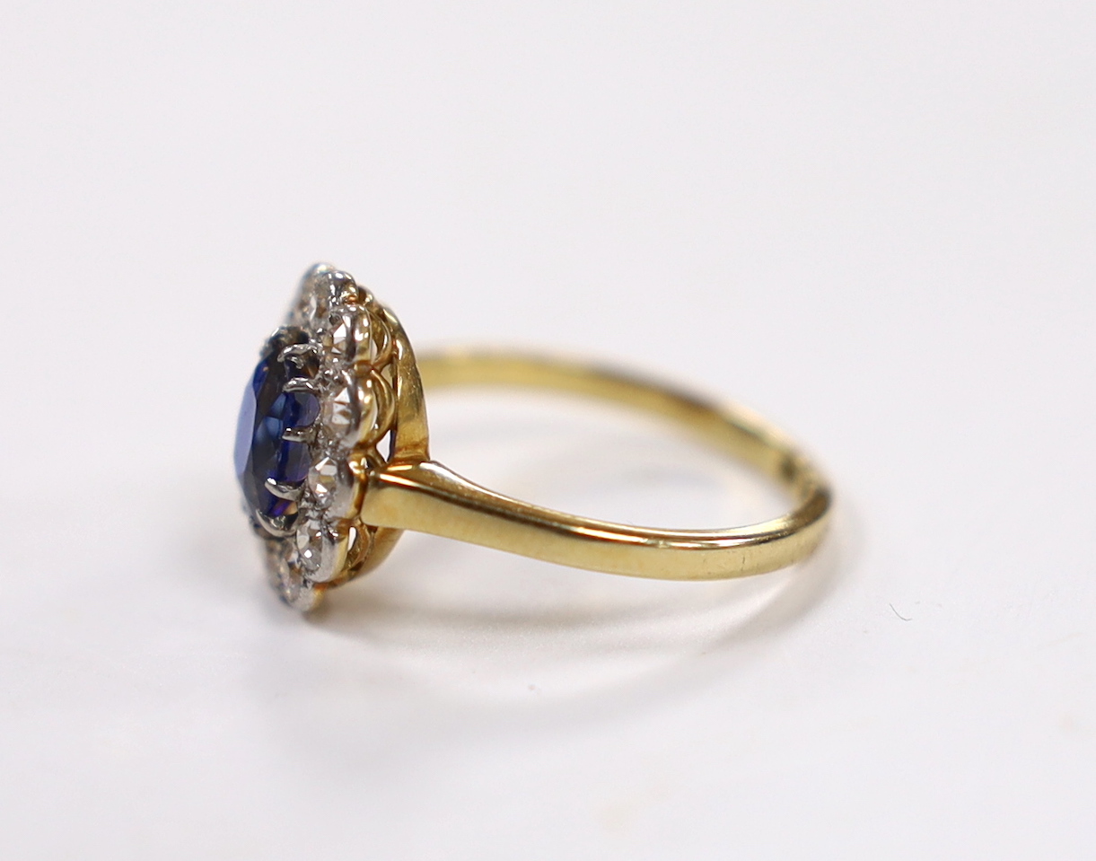A 1940's/1950's 18ct, sapphire and millegrain set diamond oval cluster ring, size L/M, gross weight 3 grams.